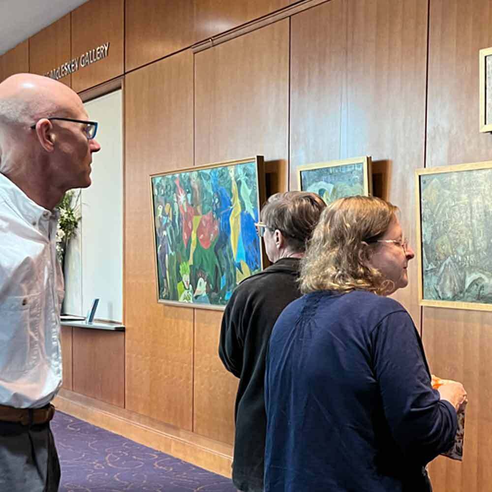 Visitors Viewing Art on Wall